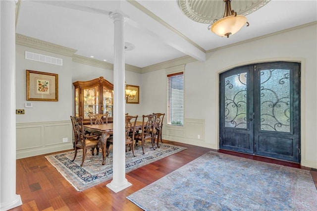 foyer entrance with visible vents, french doors, decorative columns, and wood finished floors