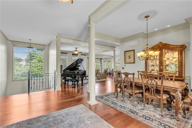 dining space featuring decorative columns, plenty of natural light, visible vents, and wood finished floors