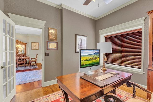 office featuring ceiling fan, baseboards, ornamental molding, light wood-style flooring, and french doors