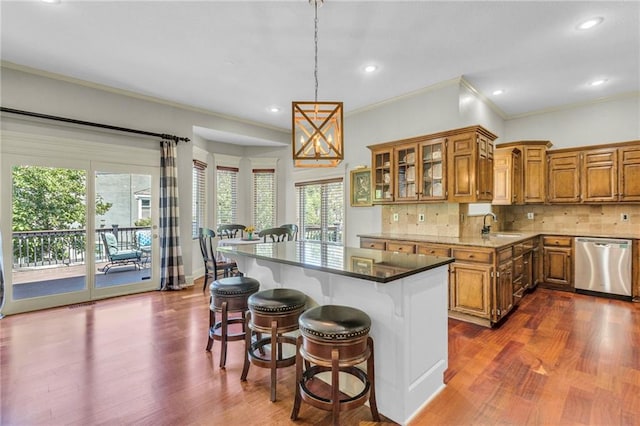 kitchen with dishwasher, brown cabinetry, tasteful backsplash, and dark wood-style flooring