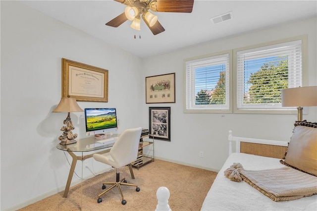 home office with a ceiling fan, carpet, visible vents, and baseboards