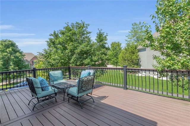 wooden deck featuring a lawn