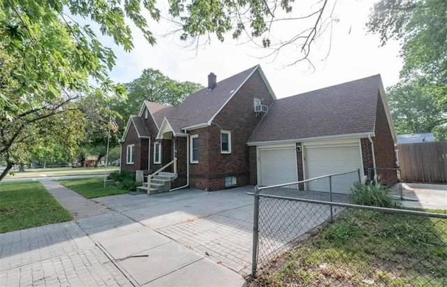 view of front of property with an attached garage, brick siding, fence, driveway, and a chimney