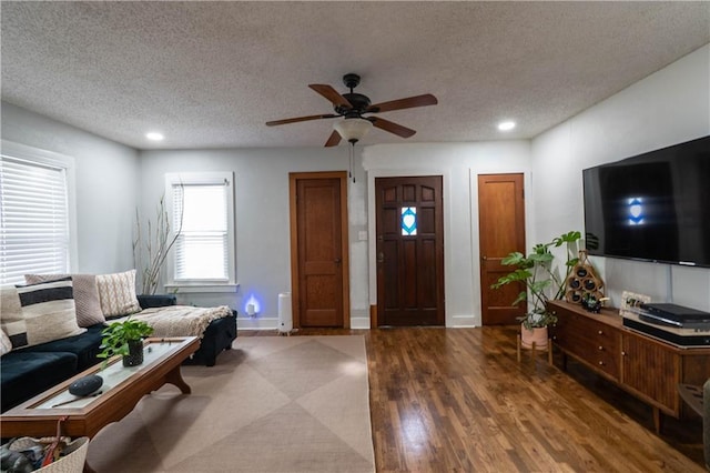 living room with recessed lighting, ceiling fan, a textured ceiling, and wood finished floors