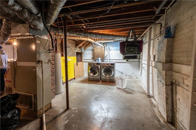 unfinished basement with heating unit, washer and clothes dryer, and gas water heater