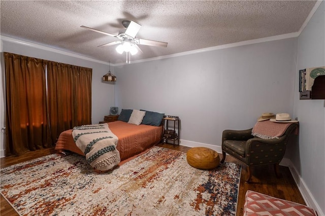 bedroom with a textured ceiling, ornamental molding, and wood finished floors