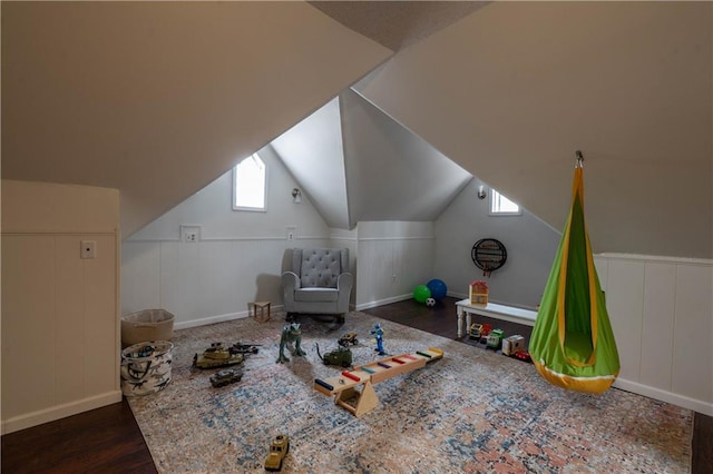 additional living space featuring lofted ceiling and wood finished floors