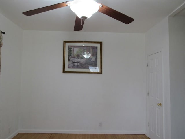 spare room featuring ceiling fan, baseboards, and light wood-style floors