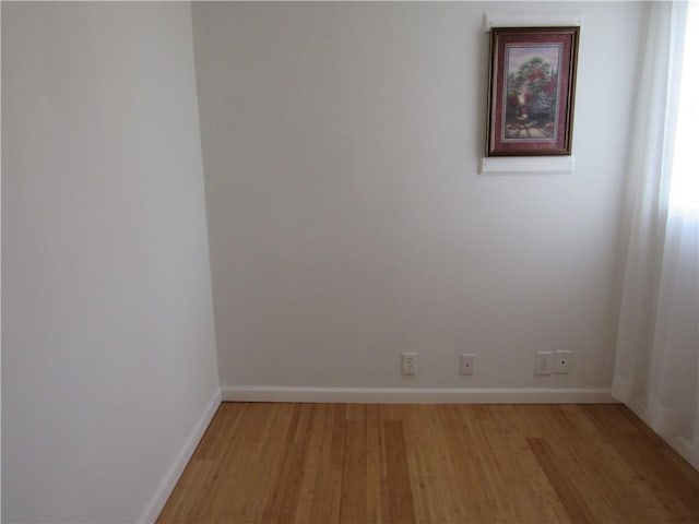 spare room with light wood finished floors and baseboards