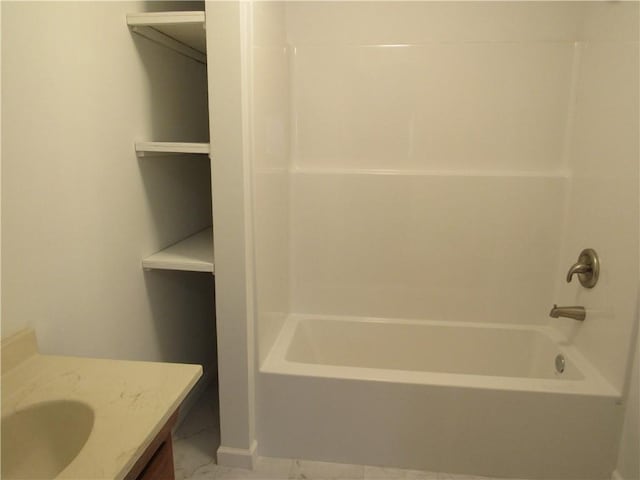 full bath featuring marble finish floor, shower / tub combination, and vanity