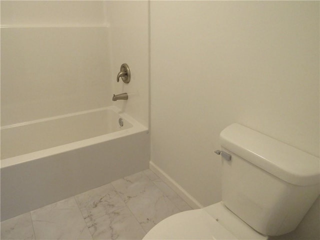 bathroom featuring marble finish floor, baseboards, and toilet