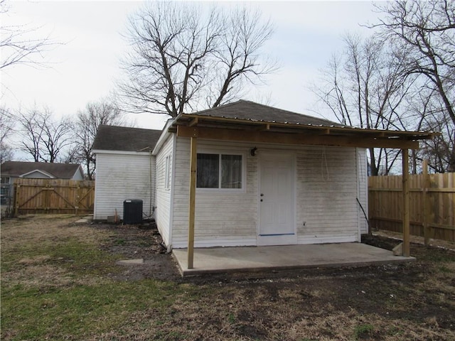 view of outbuilding with a fenced backyard and central air condition unit