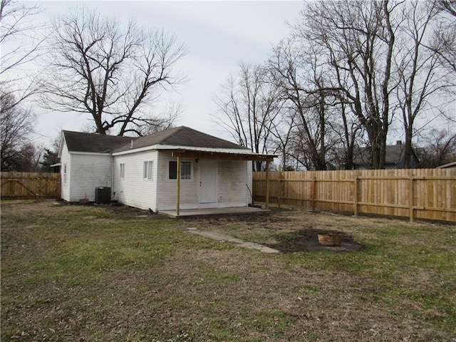 exterior space featuring a fenced backyard and central AC unit