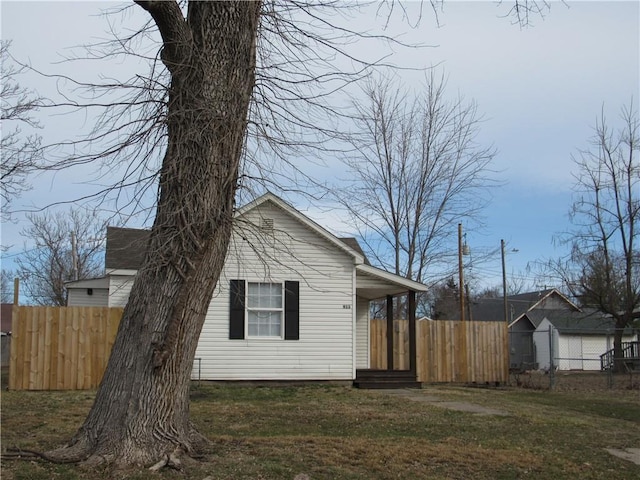 view of home's exterior with a yard and fence