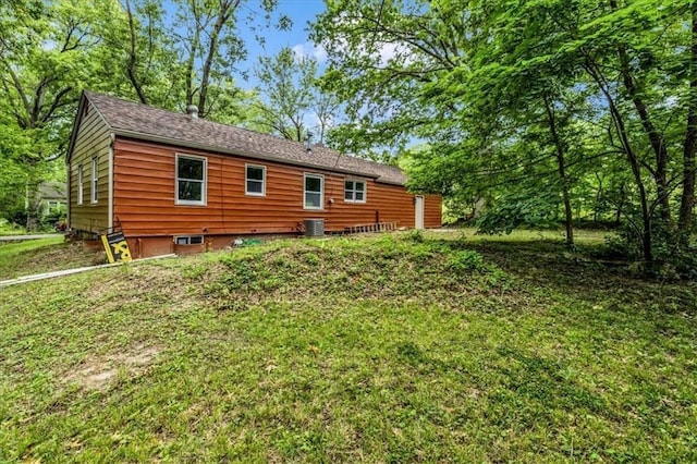 back of house featuring a yard and central AC unit