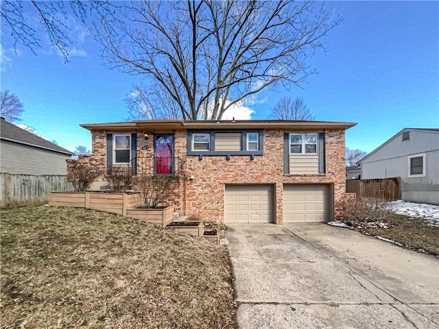 view of front of home with a garage, concrete driveway, brick siding, and fence