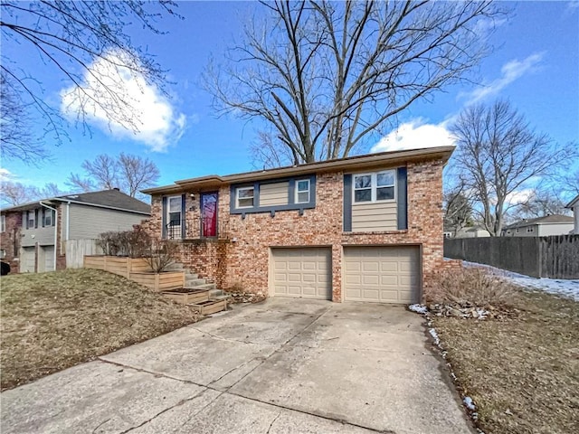 view of front of home with a garage, concrete driveway, brick siding, and fence