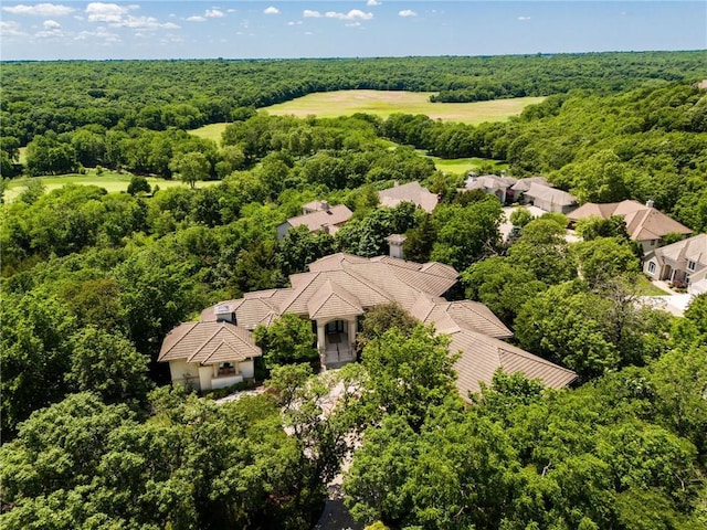 aerial view featuring a wooded view