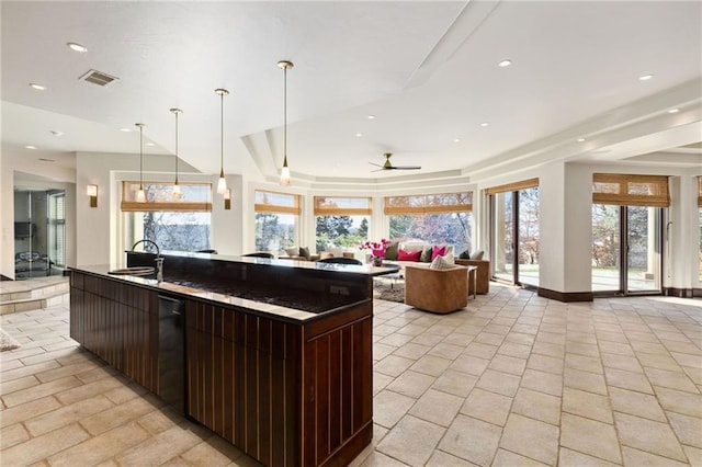 kitchen with open floor plan, a sink, visible vents, and recessed lighting