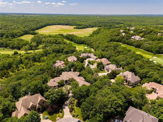 bird's eye view featuring a forest view and golf course view