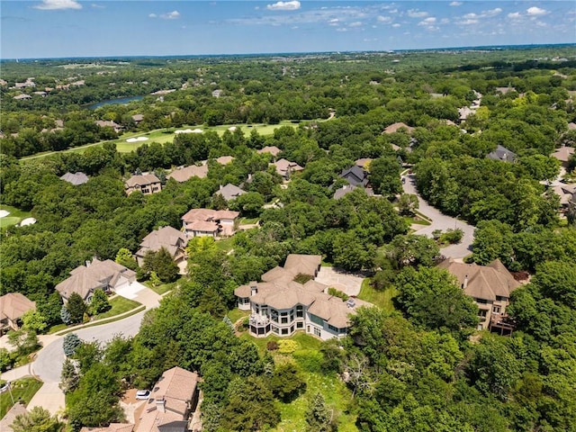 drone / aerial view with a residential view and a view of trees