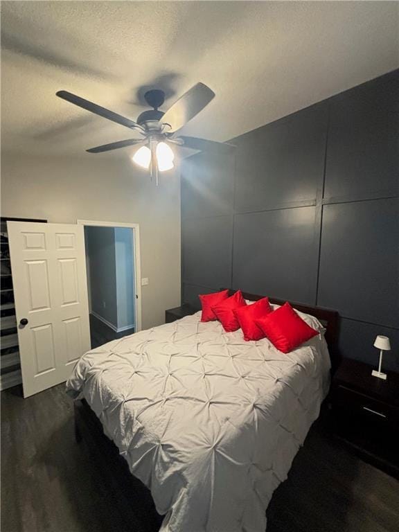 bedroom with a textured ceiling and a ceiling fan