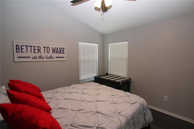 bedroom featuring vaulted ceiling, wood finished floors, baseboards, and ceiling fan