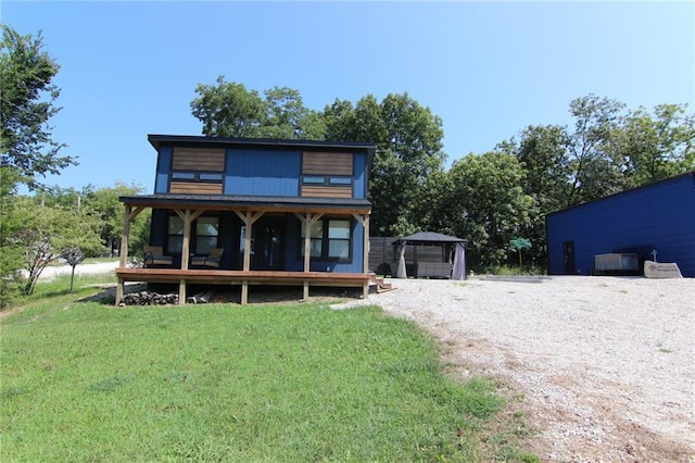 rear view of property with a yard