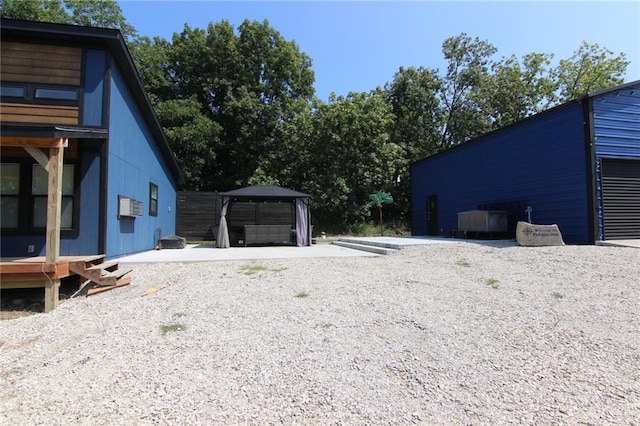 exterior space featuring a gazebo and a detached garage