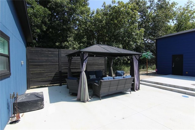 view of patio / terrace featuring an outdoor living space and fence