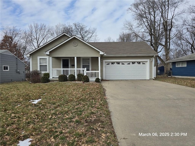 view of front of home with covered porch, driveway, an attached garage, and a front yard