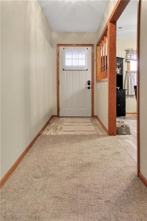 entryway with carpet and baseboards