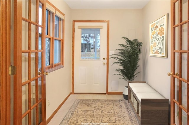 doorway featuring french doors and baseboards