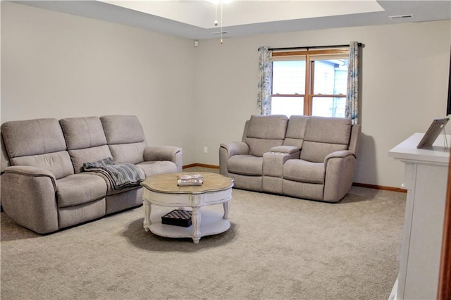 living room featuring carpet floors, visible vents, and baseboards