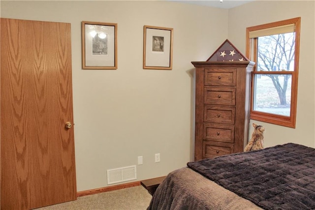 bedroom with carpet flooring, visible vents, and baseboards