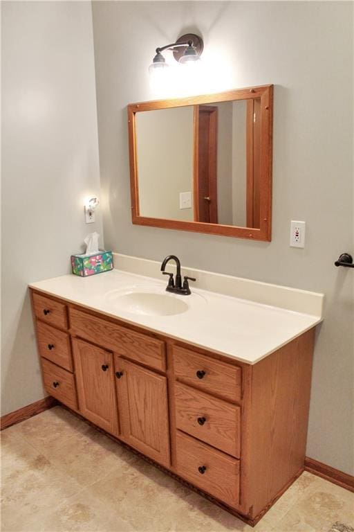 bathroom with vanity and baseboards