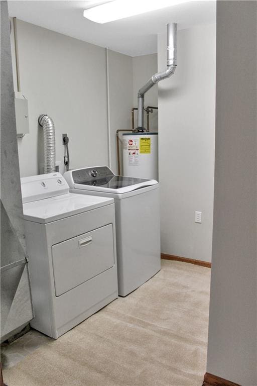 laundry room featuring laundry area, baseboards, gas water heater, and washing machine and clothes dryer