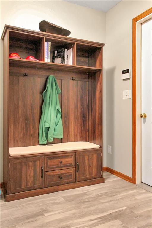 mudroom with light wood-style floors and baseboards