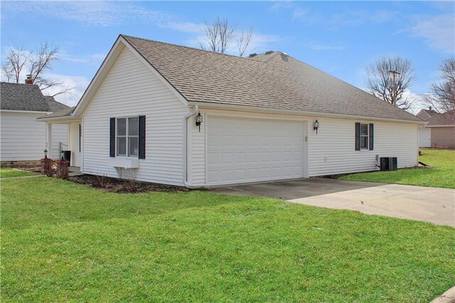 view of home's exterior featuring a shingled roof, a lawn, central AC, and concrete driveway