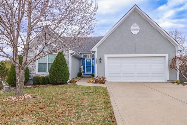 single story home featuring driveway, a front yard, an attached garage, and stucco siding