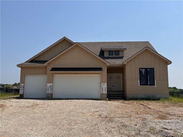 2341 Fishing Ln, Kearney, MO 64060 - view of front facade featuring board and batten siding, an attached garage, roof with shingles, and driveway