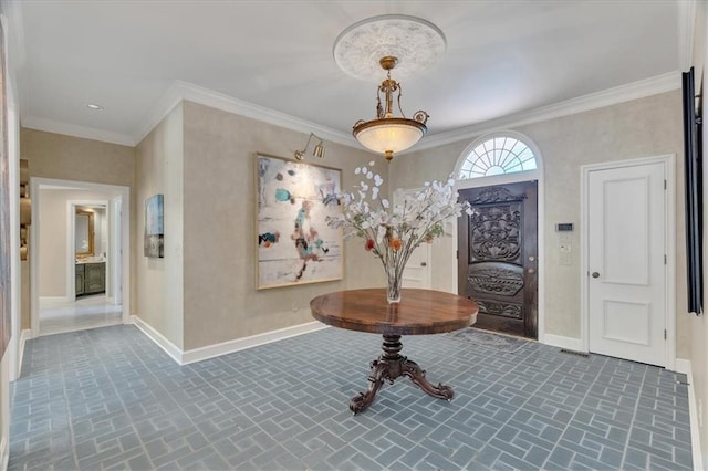 entrance foyer with brick floor, crown molding, and baseboards