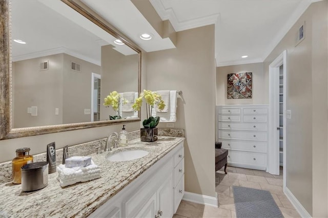 bathroom featuring vanity, crown molding, baseboards, and visible vents