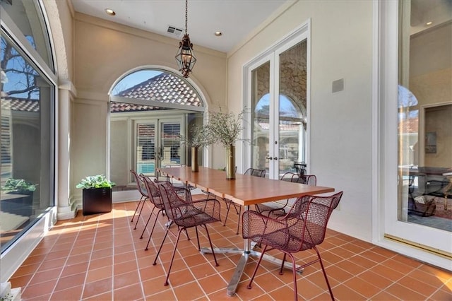 sunroom / solarium featuring a wealth of natural light, french doors, and visible vents