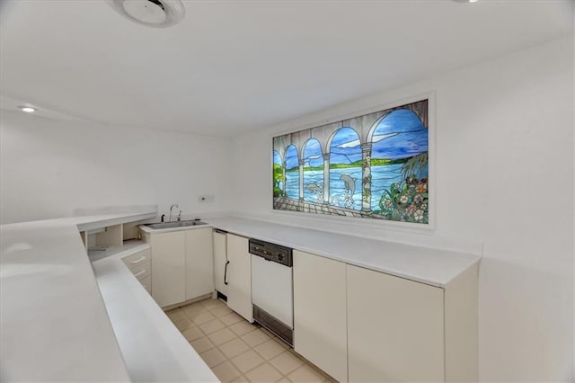 kitchen with dishwasher, light countertops, white cabinetry, and a sink