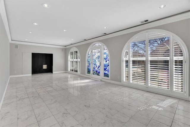 unfurnished living room with visible vents, marble finish floor, crown molding, and baseboards