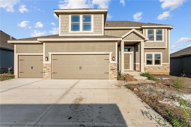 view of front of house featuring stone siding, driveway, and stucco siding