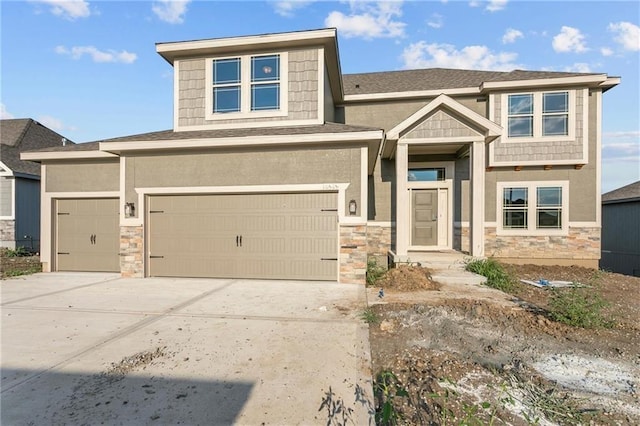 view of front of property featuring stone siding, an attached garage, concrete driveway, and stucco siding