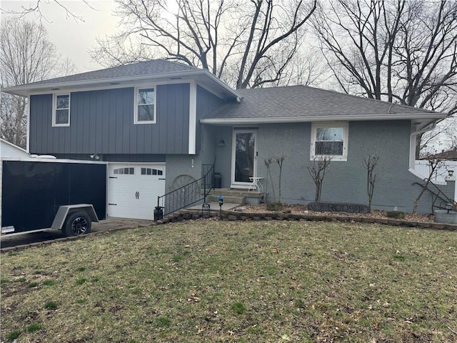 split level home featuring a garage, brick siding, a front lawn, and a shingled roof