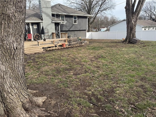 view of yard featuring a deck and fence